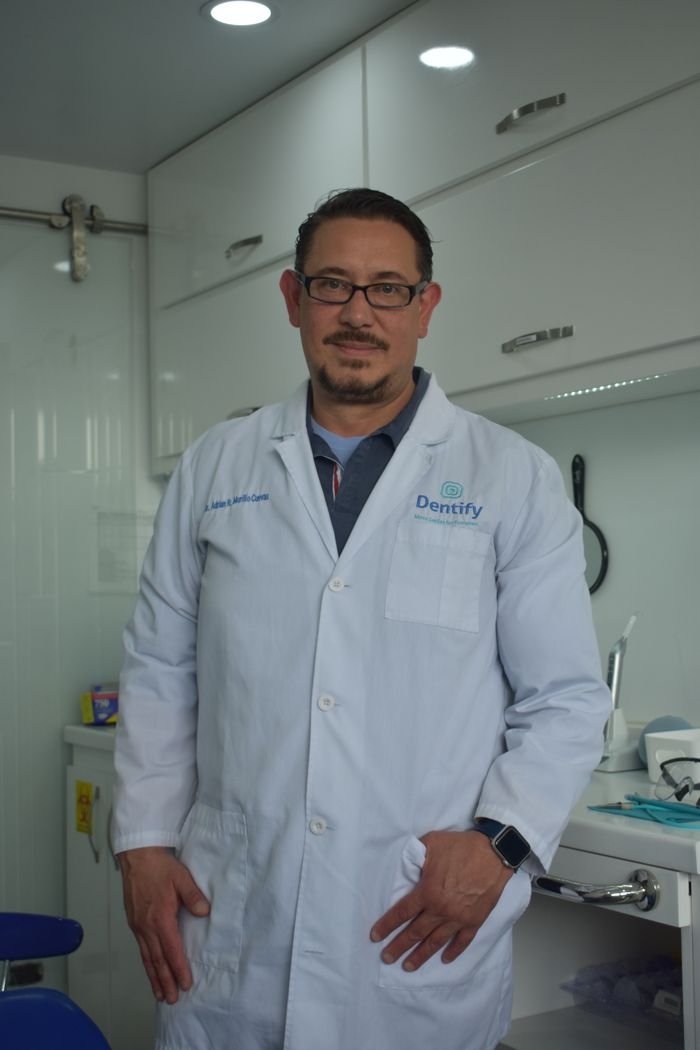 Male dentist in a modern dental clinic, showcasing a professional and welcoming environment.